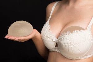 woman holding implants
